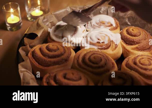 High angle close-up shot of baker hands using silicone spatula to ...