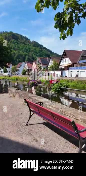 Vibrant Riverside Beautiful riverside landscape with European-style houses, green hills ...