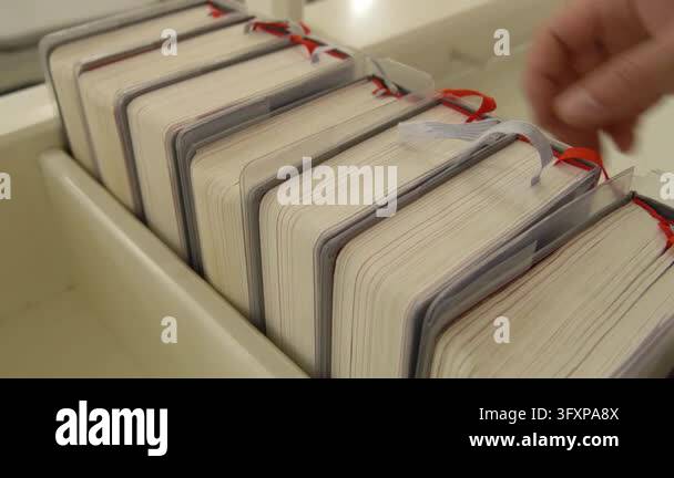 Traditional hymnals featuring red and gray ribbon markers arranged in a ...
