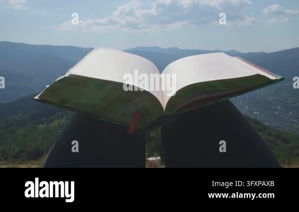 Close-up shot of an open book with flipping blank pages against a ...
