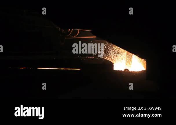 Factory Work Vector Furnace hatch spraying bright sparks inside dark steel plant. Heavy ...