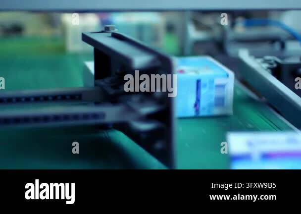 Packaged goods boxes transported factory conveyor, close up guide rails ...