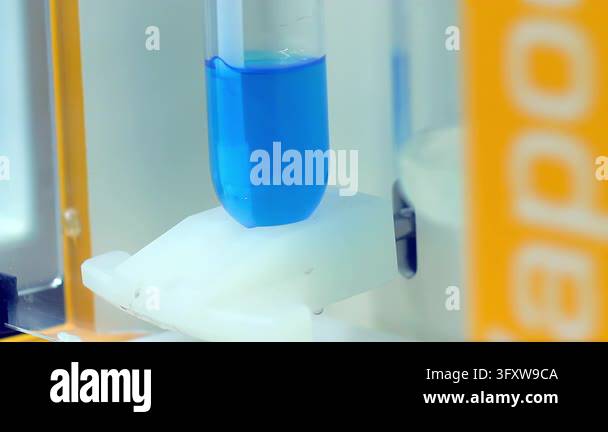 Lab Solution Mixer Test tube blue reagent mixing inside laboratory analyzer, close up ...