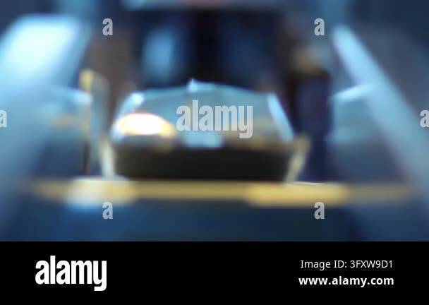 Sealed sachets moving along factory line, closeup low angle view ...