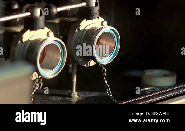 Connecting rubber hose dairy tanker outlet, close up hands locking ...