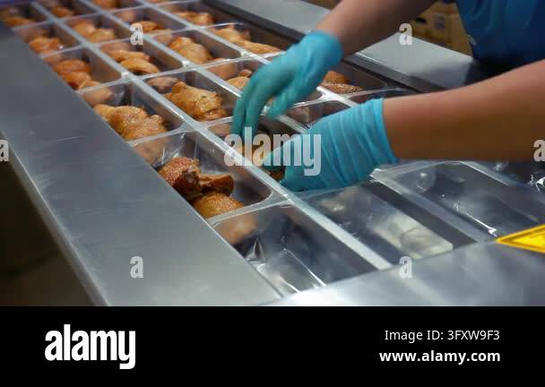 Poultry packing line food factory, worker gloved hands sorting roasted ...