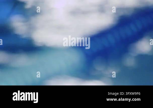 Lane rope floating rippling blue pool water, rack focus from blurred to ...