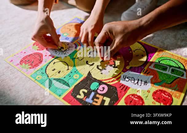 Weekend Teamwork Close up hands placing final jigsaw puzzle pieces living room carpet ...