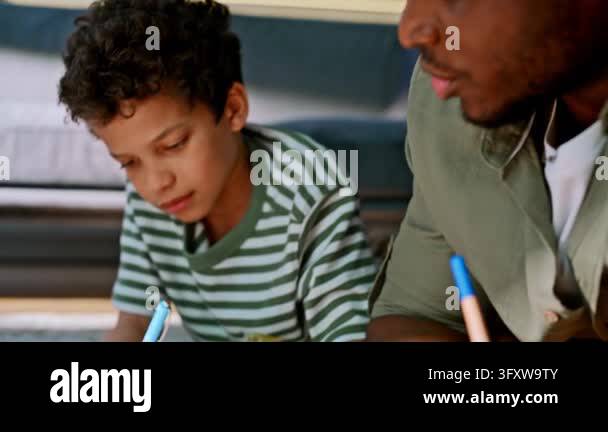African american father helping son homework home. Close up hands ...