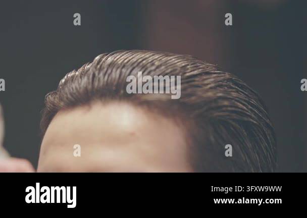 Styling slicked back hairstyle barbershop, hairdresser hands combing ...
