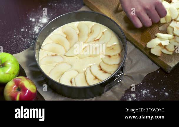 Bread Forming Table Apple pie preparation kitchen table, hand closeup arranging fruit ...
