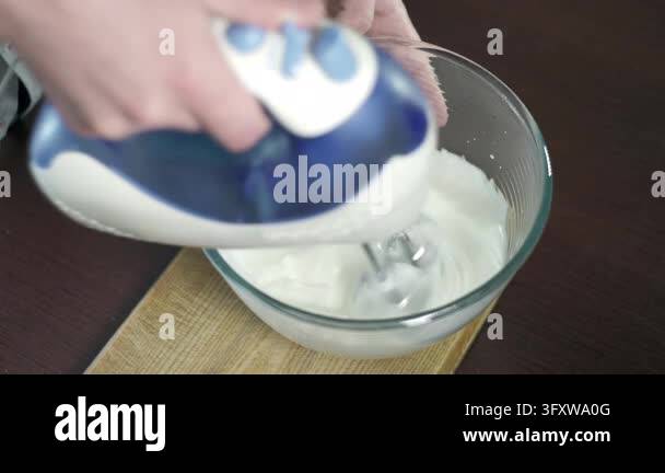 Meringue preparation home kitchen, cook whisks egg whites electric ...