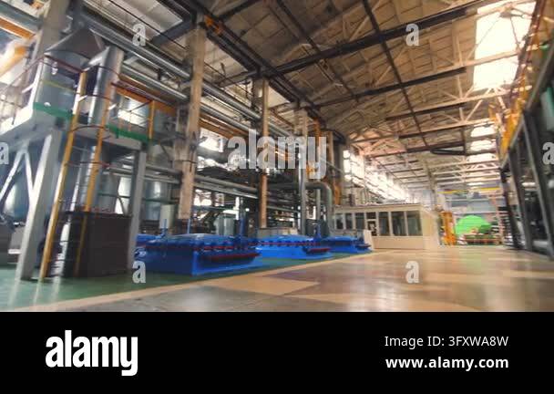 Empty old factory interior steel pipelines, pumps, heat exchangers ...