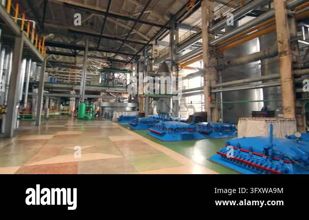 Tracking shot moving through heavy industry production hall. Steel ...