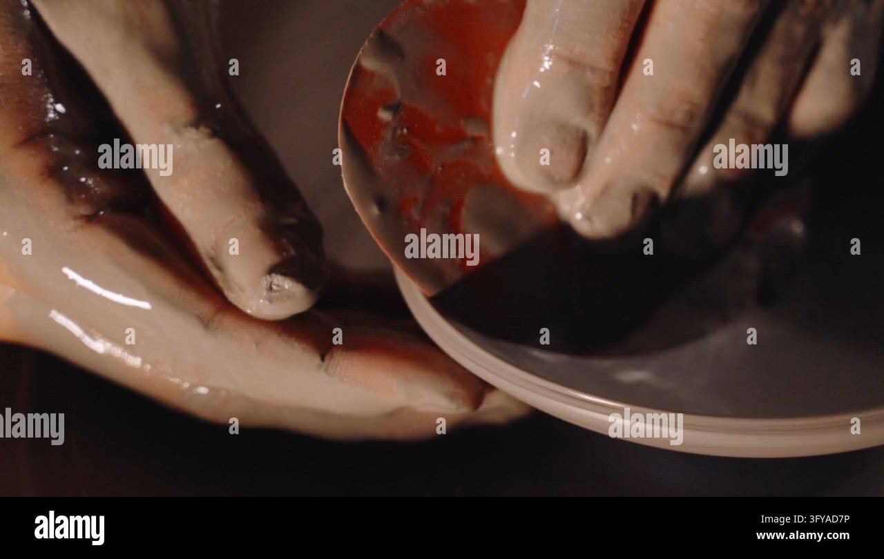 Hands Shaping Clay on a Pottery Wheel in a Workshop Setting Stock Video ...