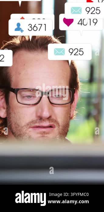 Animation of media icons over caucasian businessman using computer in ...