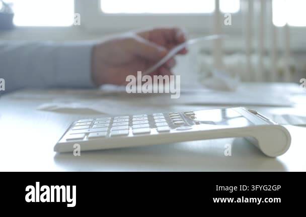 Businessman Working with Invoices, Makes Financial Calculations with ...