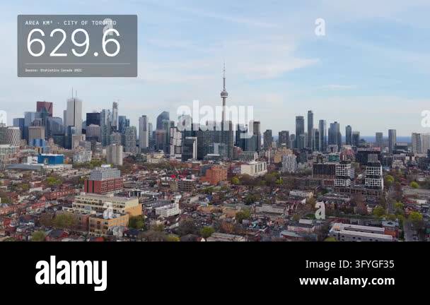Aerial tracking shot of Toronto, Canada: skyline over row houses with ...