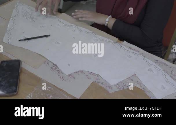 Tracing Pattern Teplates Cinematic footage of a woman fashion designer tracing traditional batik ...