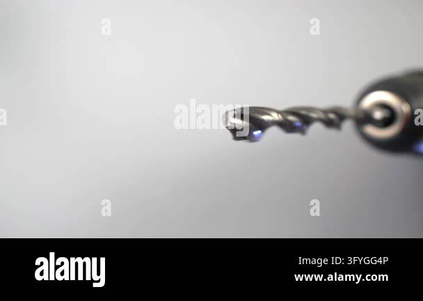 Extreme macro dolly shot showing a steel twist drill bit held in an ...