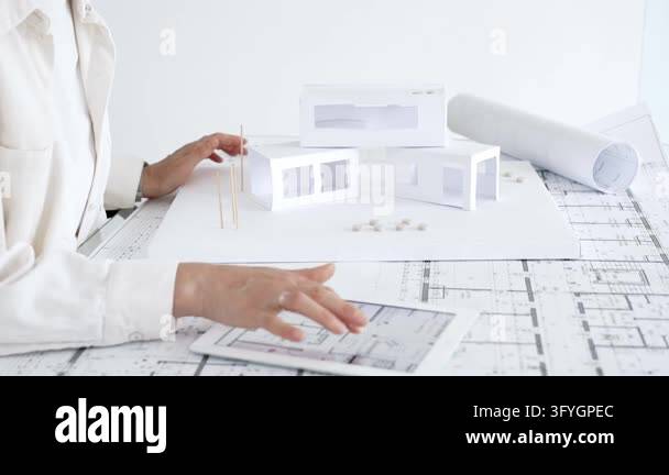 Architect hands using a compass and ruler on a detailed blueprint ...