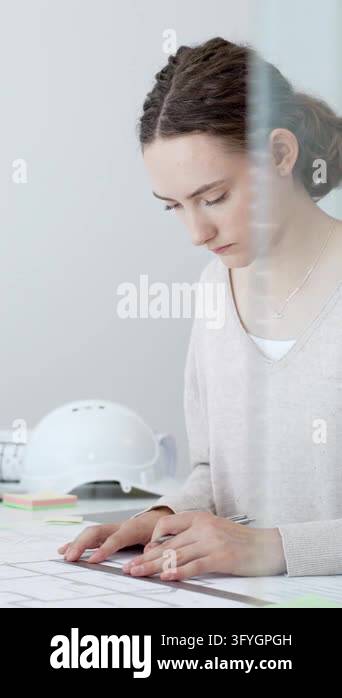 Workign Drawing Engineering Female architect drawing blueprints, designing building plans at desk ...
