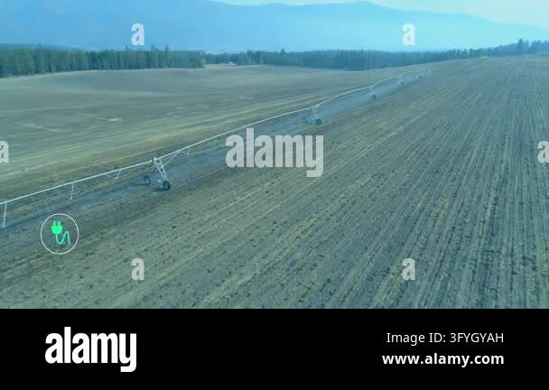 Pivot irrigation system spanning tilled field, animation starting ...