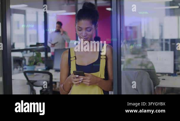 Woman typing on smartphone against glass in office, activating animated ...