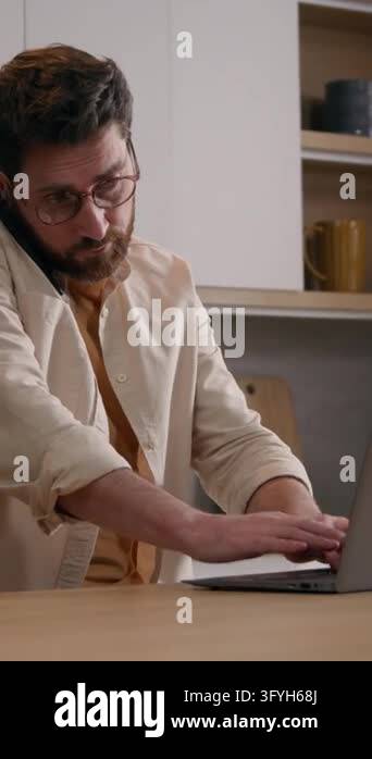 Man With Glasses Using Computer Busy Caucasian multitasking business man using laptop and talking on ...