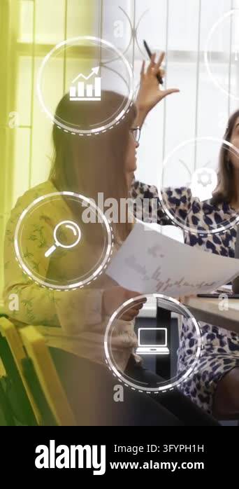 Animation of multiple digital icons against diverse colleagues ...