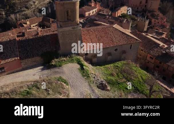 Drone camera soaring past church bell tower, revealing ancient hillside ...
