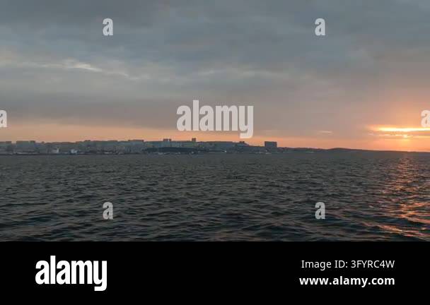 Scenic view of a breathtaking sunset over the calm sea horizon from a ...