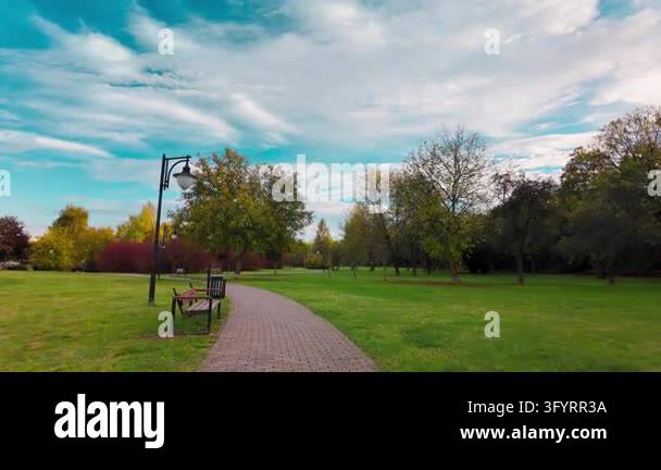 Smooth tracking shot forward along a paved walkway featuring an empty ...