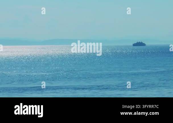 High-angle view of shimmering sunlight dancing on calm sea water with a ...