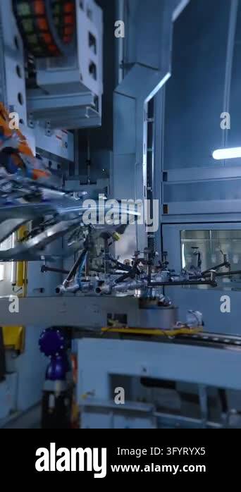 Vertical Line Panel Robotic arm lifting stamped car body panel in automotive factory ...
