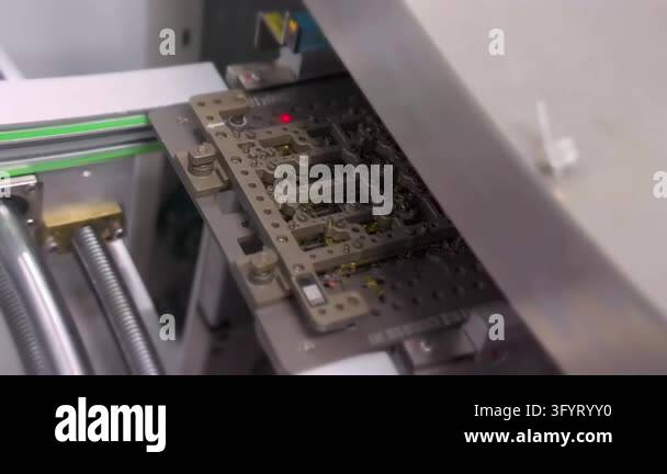 Circuit board panel in carrier moving on conveyor into machine. SMT ...