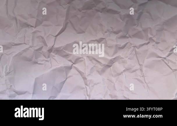 Crumpled white paper with soft light moving irregularly along the edges ...