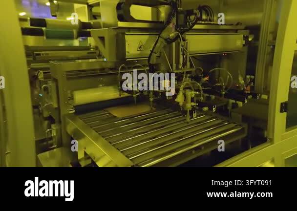 Cleanroom 360 Electronics factory cleanroom with yellow light. Automated machine and ...