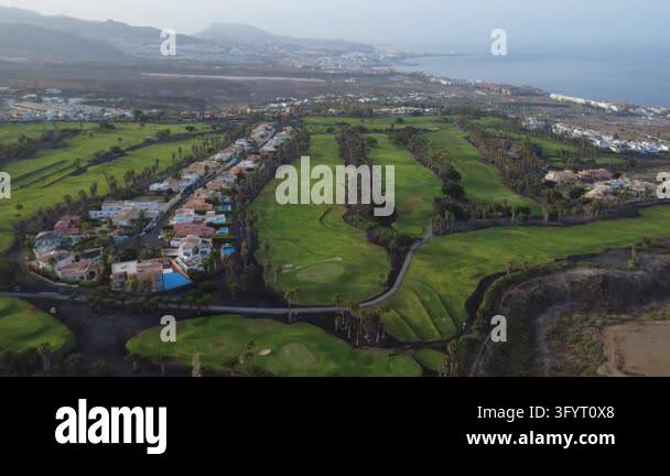 Aerial drone view of a wide golf course landscape with villas, fairways ...