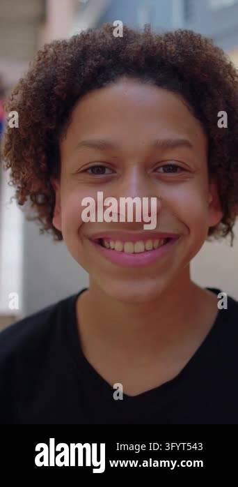 Afro Latino boy looking at camera with a cheerful grin on a quiet ...