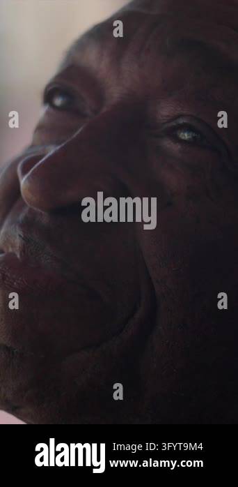 Tight close-up of a contemplative African American senior man looking ...