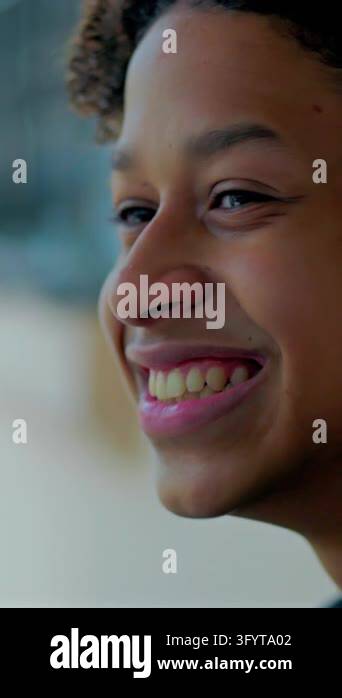 Close-up of a joyful Hispanic boy of African descent smiling cheerfully ...