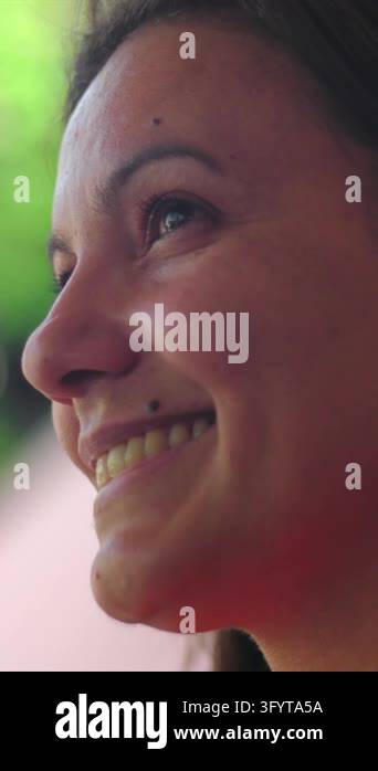 Side profile of a happy Hispanic woman smiling warmly and looking up ...