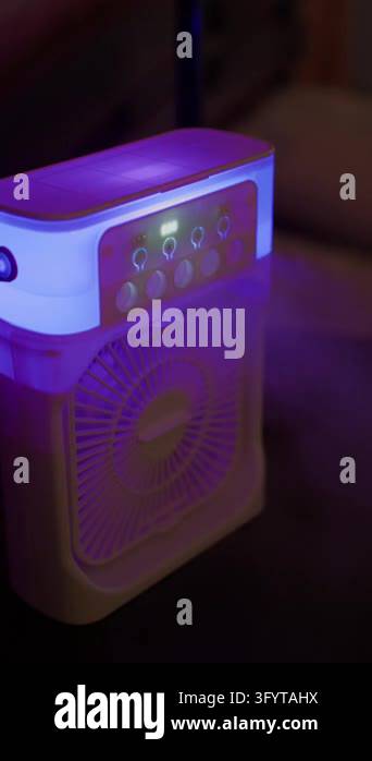 Portable air cooler illuminating room with ambient purple LED light ...