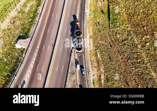 Oversized industrial cargo transportation on a long trailer with nearby ...