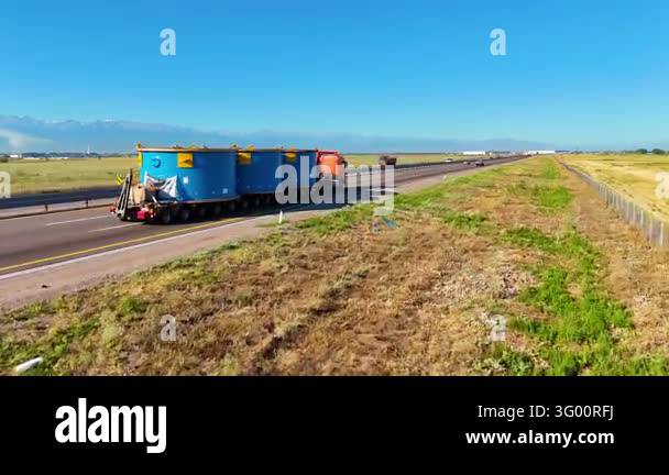 Heavy haulage of large blue industrial cargo modules on an extended ...