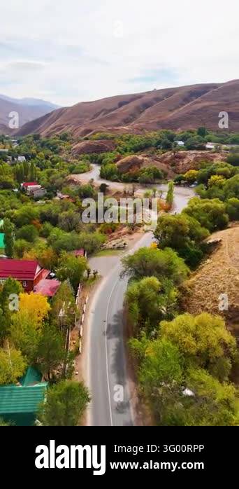 Curving Asphalt Road Through Dry Hills and Green Trees in Kazakhstan ...