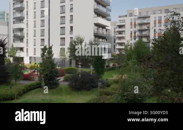 Modern residential apartment complex features landscaped green ...