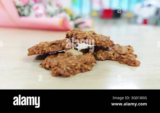 Rajjsin Oatmeal raisin cookies with cashew nuts on a light wooden table Stock ...