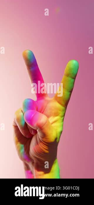 Peace or Victory Gesture Hand in Rainbow Light over Pink Background in ...
